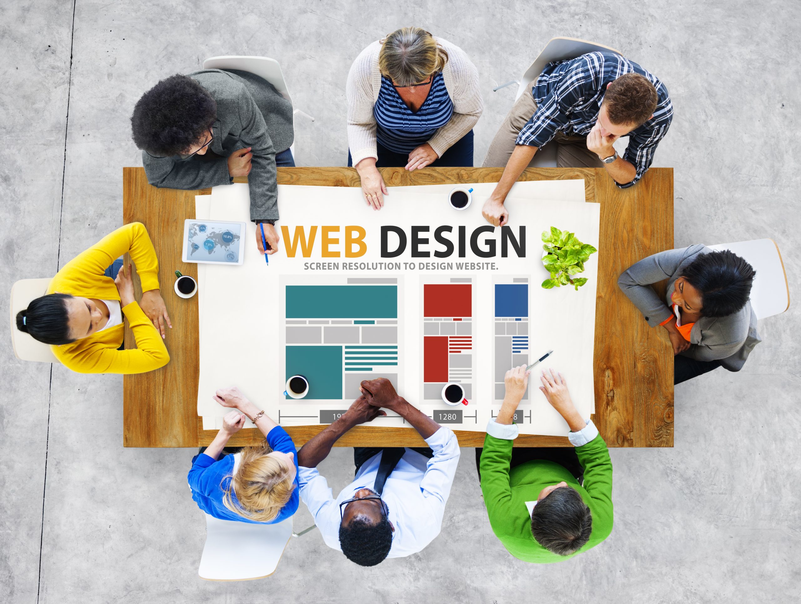people sitting around a table discussing web design